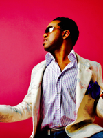 Red background with man looking to his side wearing sunglasses