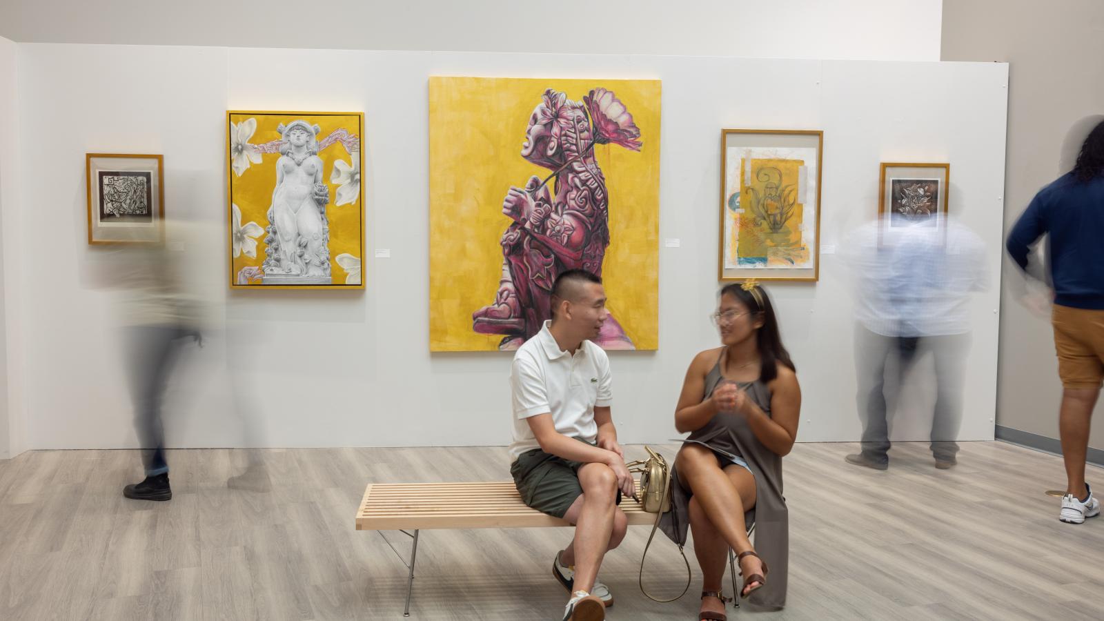Patrons sitting in the gallery