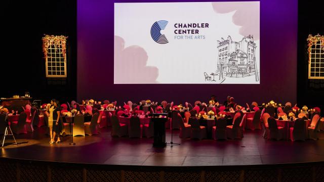 Round tables on top of the mainstage, decorated for a fundraising event