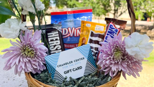 CCA gift card sitting in a basket along with flowers and candy.