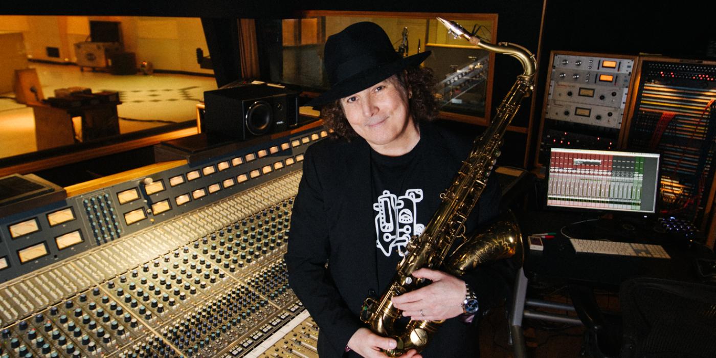 boney james stands in the recording studio with his saxophone
