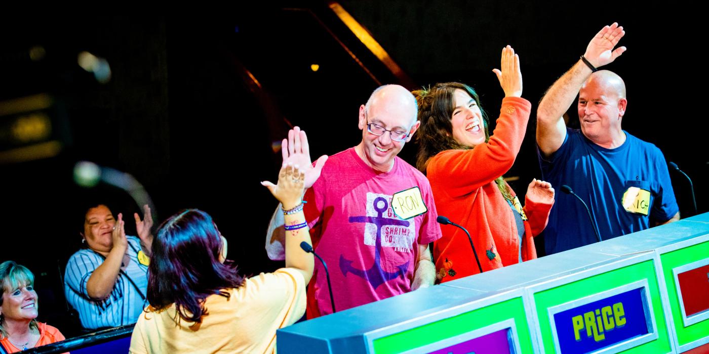 four contestants cheering and giving high fives to each other