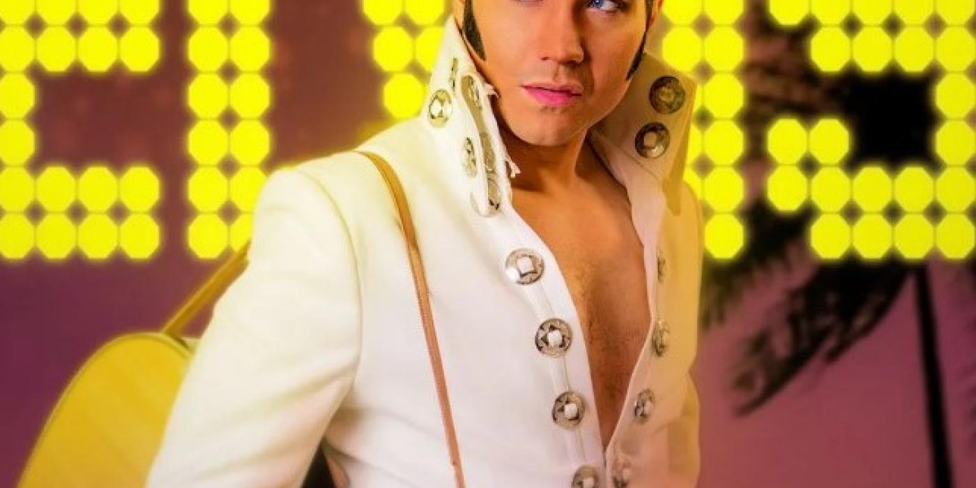 Elivs tribute artist stands with guitar