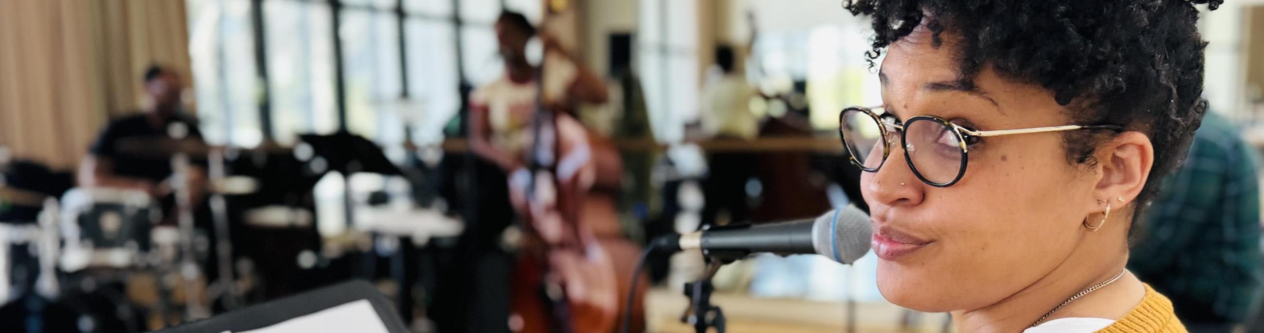 Ashli in a room of musicians