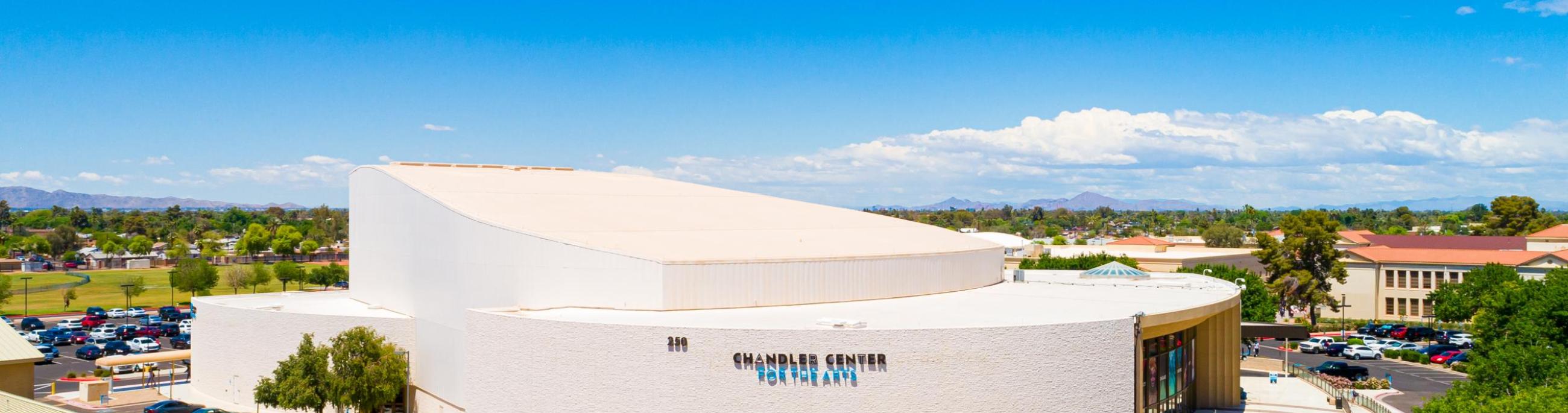 An aerial view of the performing arts center from the south with blue skies in the background