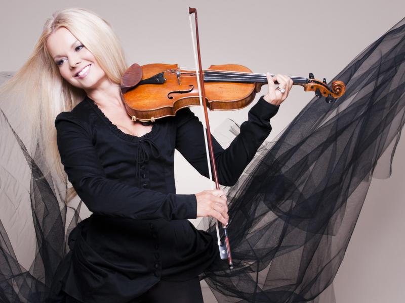 Woman in black tulle dress playing violin dressed