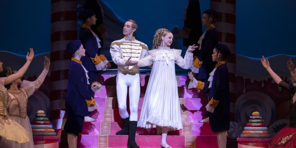 the prince and princess in the Nutcracker walk down some stairs