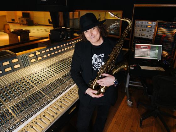 boney james stands in the recording studio with his saxophone