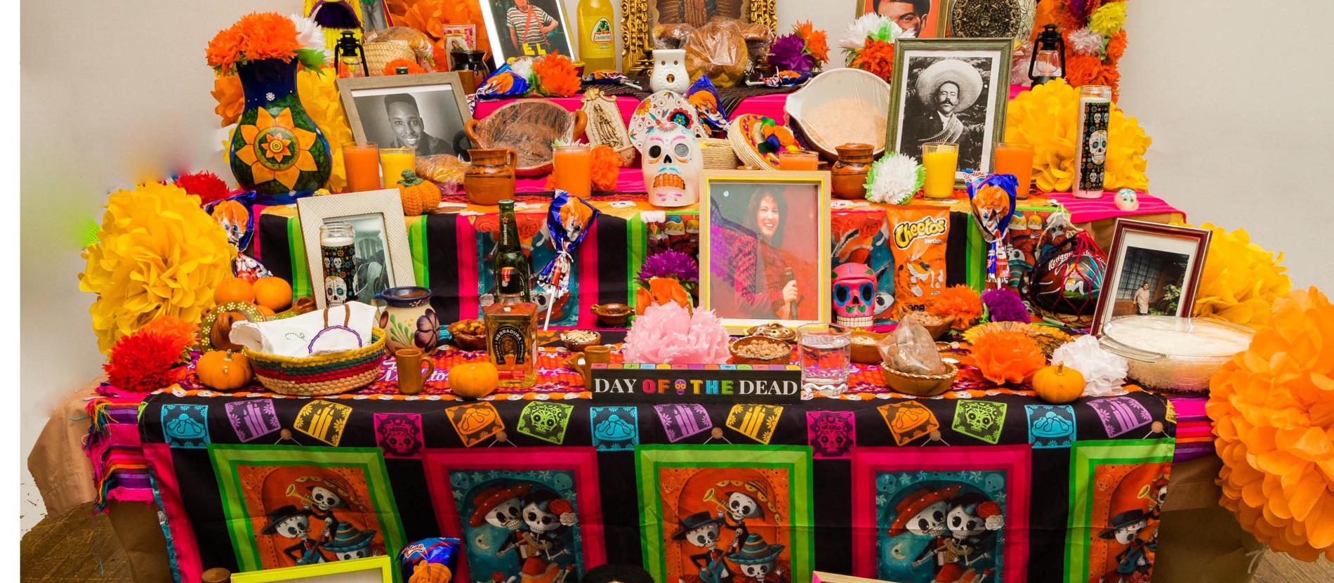 Community altar laden with photos and treats.