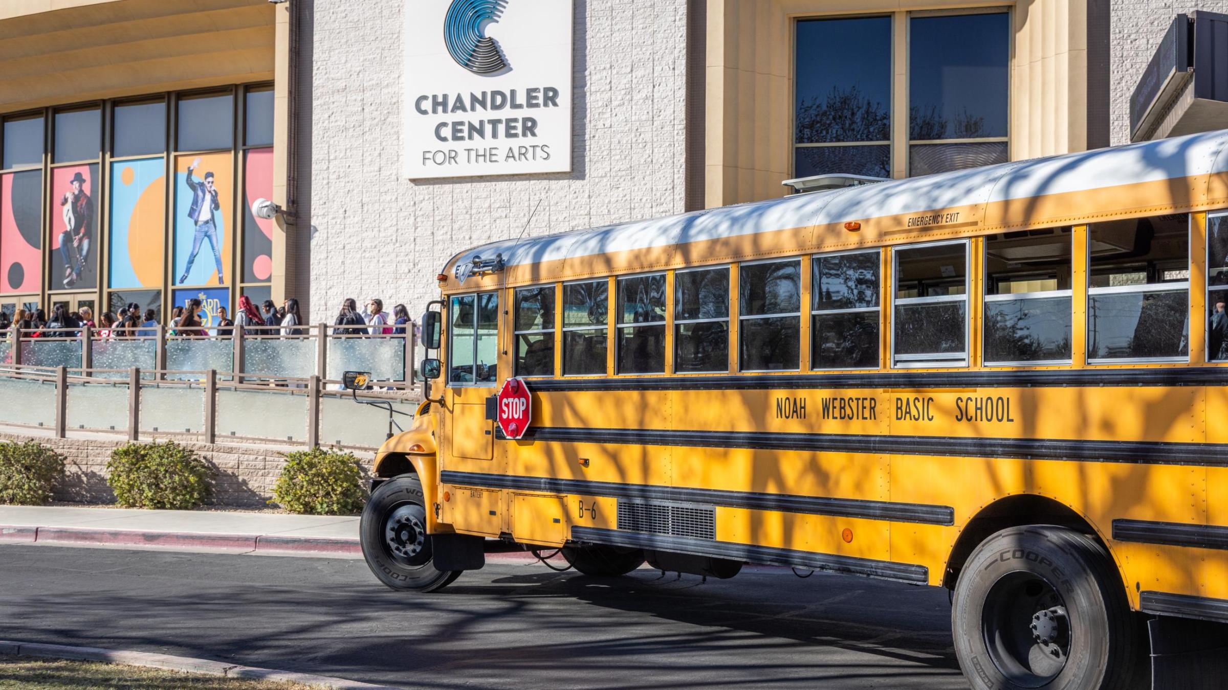 school bus parked outside of Chandler Center for the Arts and box office sign