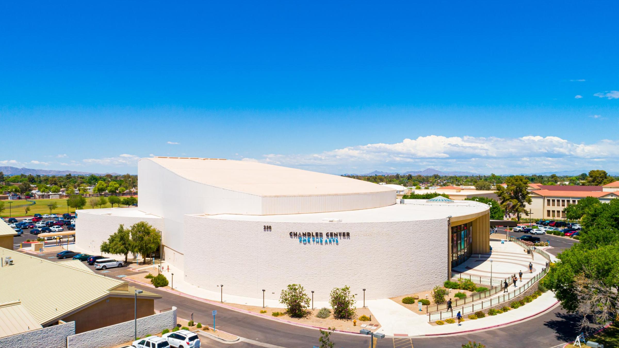 An aerial view of the performing arts center from the south with blue skies in the background